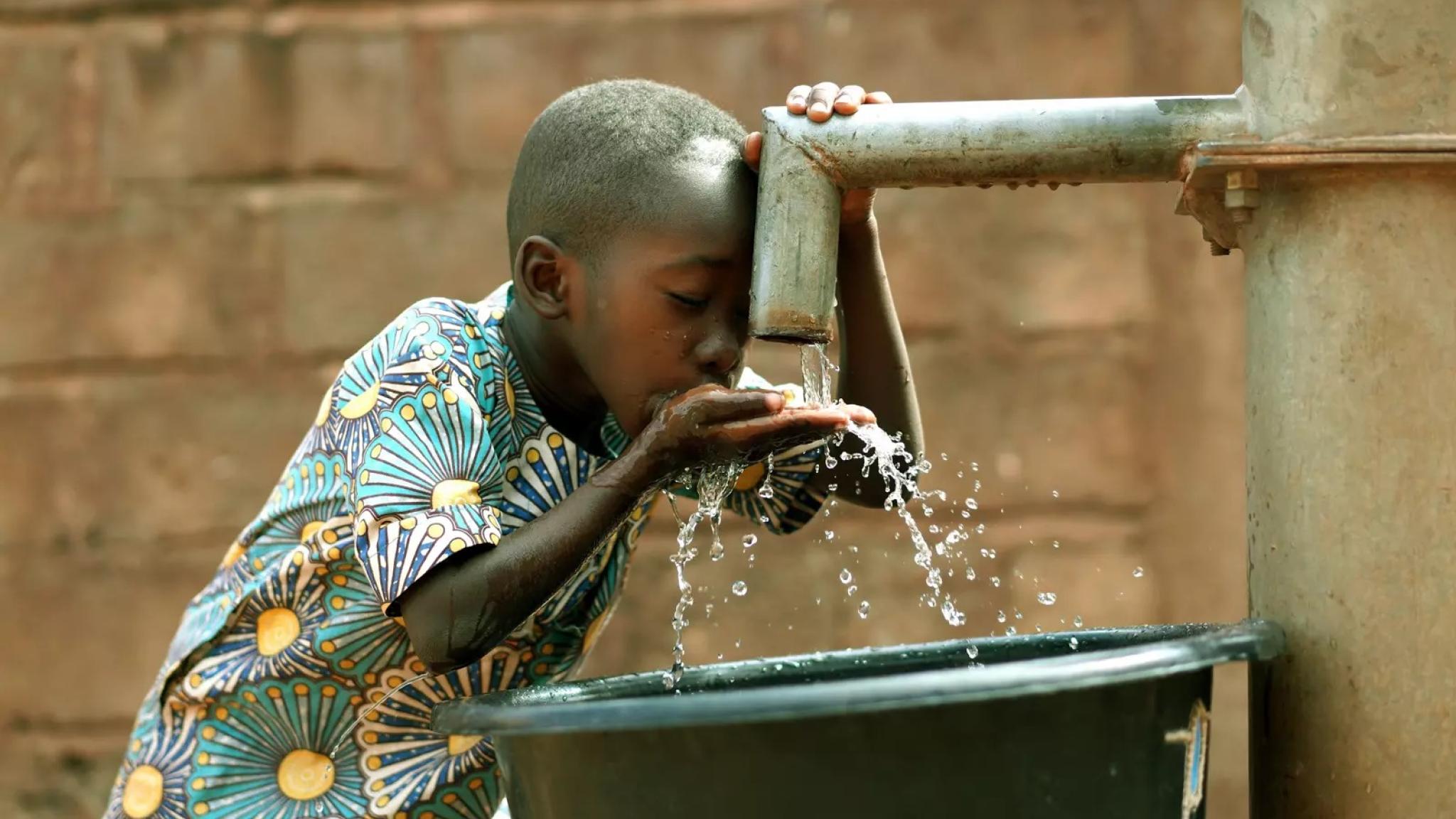 Boy drinking water Uganda