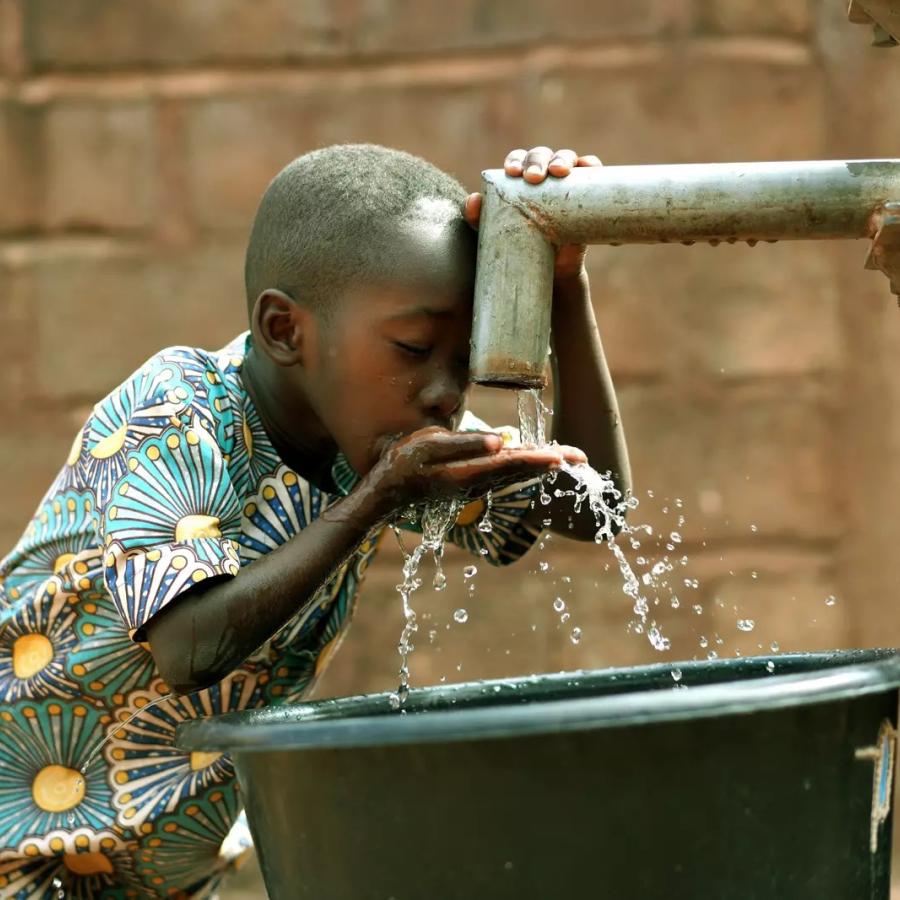 Boy drinking water Uganda